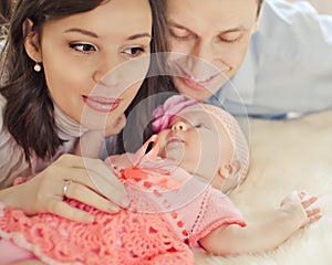 Mother, father and daughter in bed