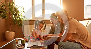 Mother, father and daughter disassembling toy cube