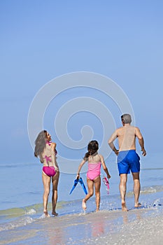 Mother, Father & Daughter Family Running on Beach