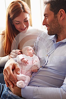 Mother And Father At Home With Newborn Baby