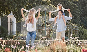 Mother, father and kids in a garden as a happy family outdoors in summer to relax, bond and have fun together. Flowers