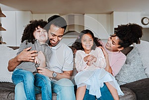 Mother, father and kids on sofa, playing and happy family bonding together in living room. Smile, happiness and parents