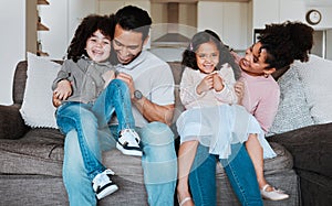 Mother, father and kids on sofa, playing and happy family bonding together in living room. Smile, happiness and parents