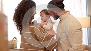 Mother and father kiss newborn baby with love, care and bonding together at home for family lifestyle, child healthcare
