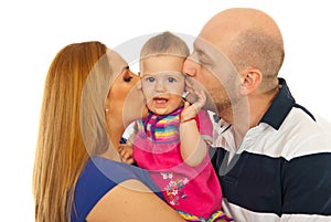 Mother and father kissing amazed baby