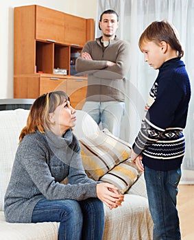 Mother and father scolding teenager son