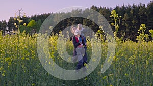 Mother, father and son dancing and playing in the rapeseed field Slow motion