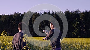 Mother, father and son dancing and playing in the rapeseed field Slow motion