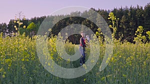 Mother, father and son dancing and playing in the rapeseed field Slow motion