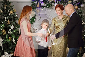 Mother, father, son and daughter hold candles