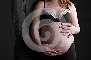 Mother and Father Supporting Pregnant Bump