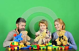 Mother and father with their son playing with colored blocks