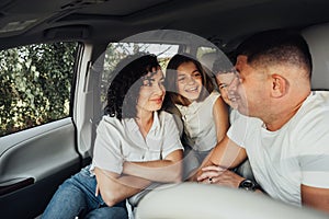 Mother and Father with Two Teenage Children on a Weekend Road Trip, Happy Four Members Family Traveling by Minivan Car