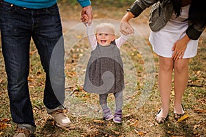 Mother and father walking with a baby daughter