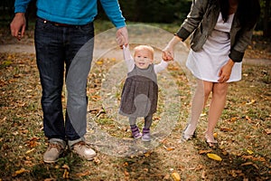 Mother and father walking with a cute baby daughter