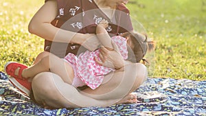 Mother feed breastmilk to daughter