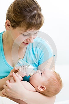 Mother feeding baby from bottle