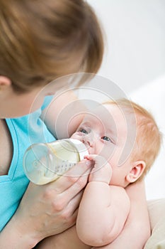 Mother feeding baby from bottle