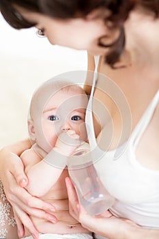 Mother feeding baby from bottle