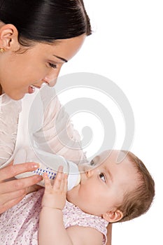 Mother feeding baby daughter