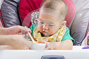 Mother feeding baby food