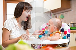 Mother feeding baby with spoon