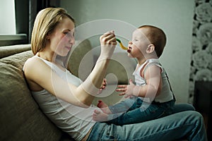 Mother feeding baby with a spoon