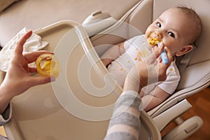 Mother feeding baby using spoon