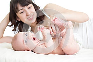 Mother feeding from bottle her baby