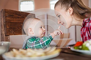 Mother feeding child. First solid food for young kid