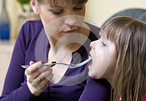 Mother feeding daughter