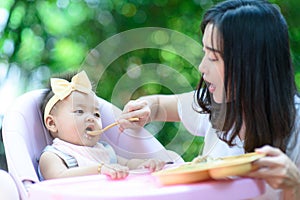 Mother feeding food baby