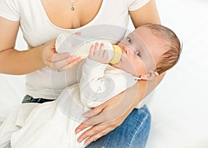 Mother feeding her 3 months old baby from bottle
