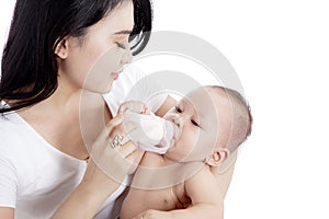 Mother feeding her baby from a bottle