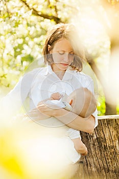 Mother feeding her baby with breast photo