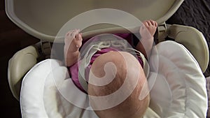 Mother feeding her baby girl with a spoon.