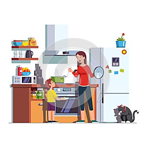 Mother feeding son at home kitchen