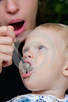 Mother feedings boy