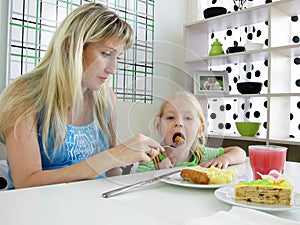 Mother feeds child in cafe