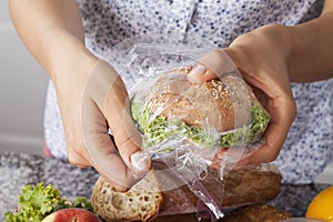 Mother foiling a sandwich