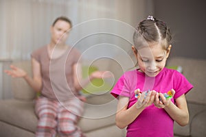 Mother frustrating that her daughter eat many candies.