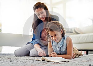 Mother, girl and help with book on floor for learning, homeschool and writing for essay or english literature assignment
