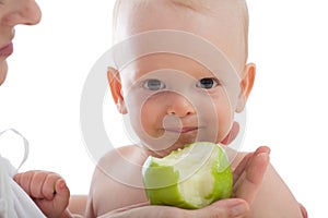 Mother give green apple to her son