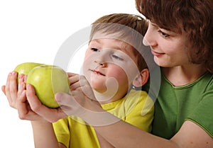 Mother gives son an apple