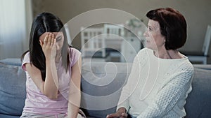 Mother giving advice to upset daughter
