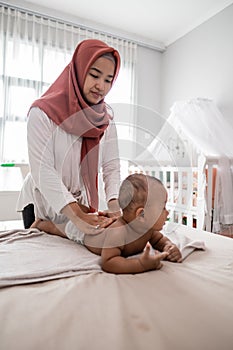 Mother giving a baby boy massage