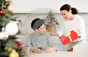 Mother giving gift to son