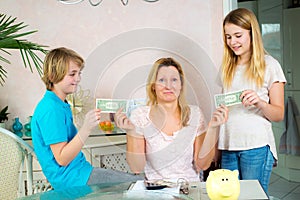 Mother giving her children pocket money