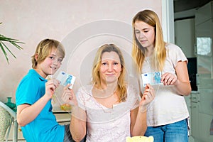 Mother giving her children pocket money