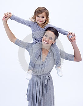 Mother giving her daughter piggyback ride